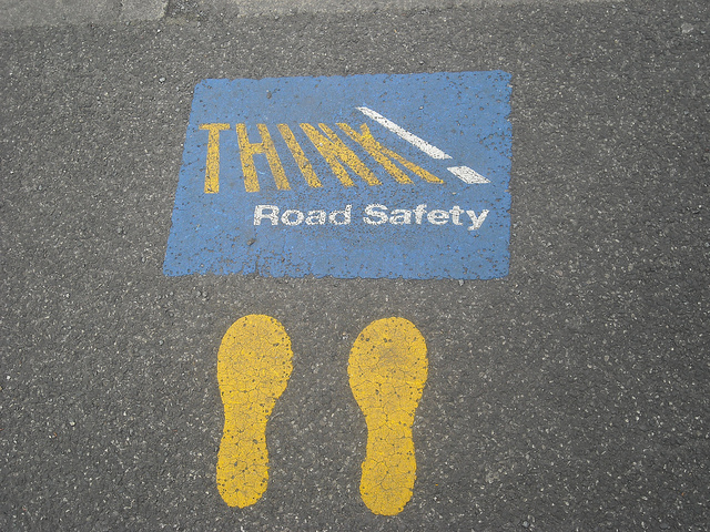 Pavement painted with "Think! Road Safety"