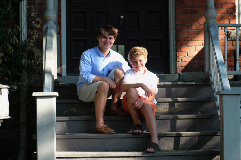 Two brothers sitting on porch steps