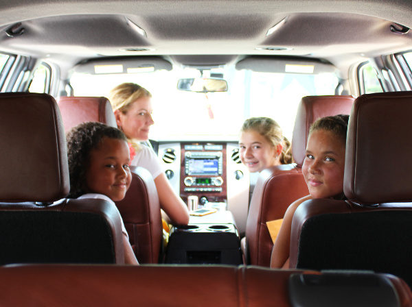 Kids in car looking back at camera