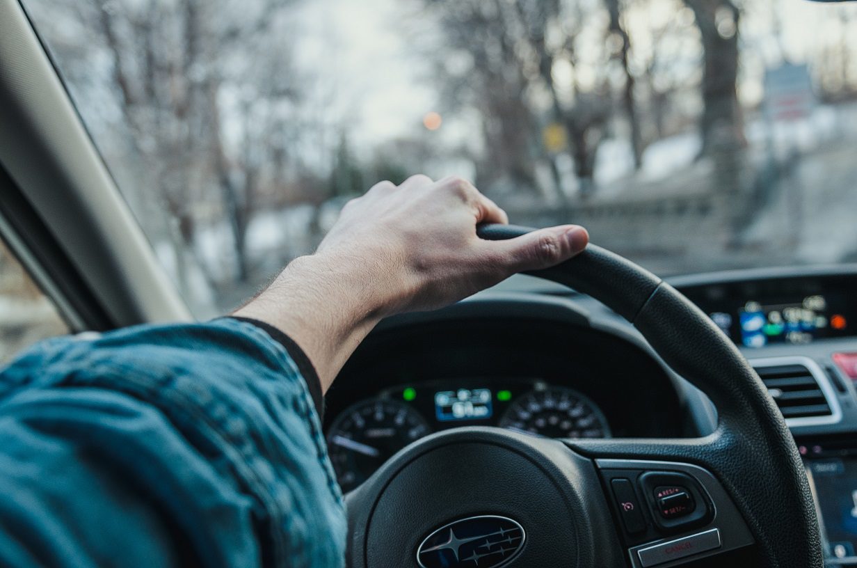 Hand on a steering wheel