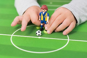 Child playing with soccer Legos