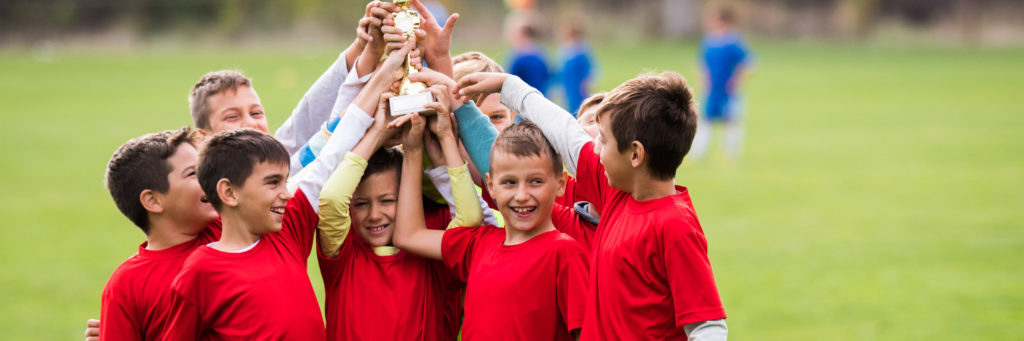 kids holding a trophy