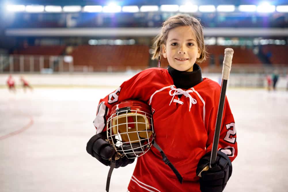 smiling girl in hockey gear