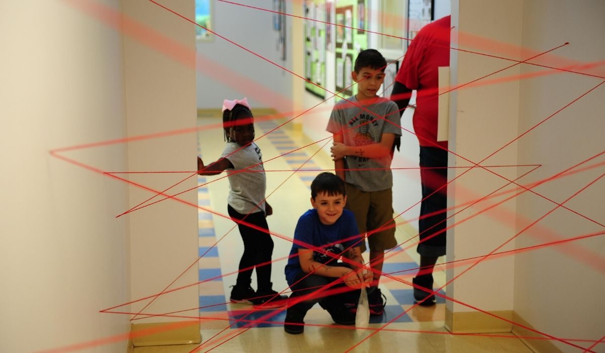 kids looking at a maze out of tape